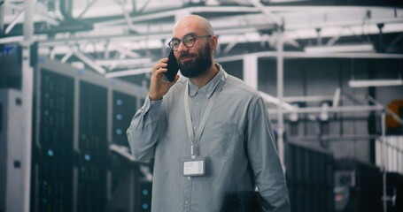 Data Center Manager Taking Critical Business Call. IT Specialist in Server Hall Handling Critical Business Call on Smartphone. Concept Client Liaison and Professional Communication in IT Management.