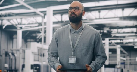 Data Analysis, Engineer Auditing Infrastructure With Digital Tablet. Serious Male IT Engineer Auditing Systems in Large, Modern Data Center. Data Integrity, Professional Control, and IT Analysis.