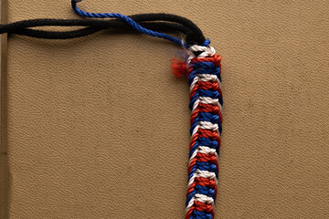Macro shot of blue, red, and white Paracord Bracelet threads