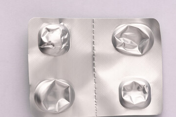 Silver blister pack from tablets with empty compartments, crumpled
