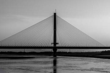 Obraz premium Black and white view of the Mersey Gateway Bridge spanning the River Mersey
