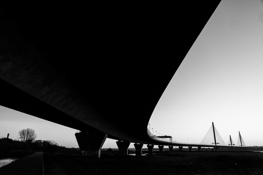 Black and white view beneath the Mersey Gateway Bridge spanning the River Mersey - Powered by Adobe