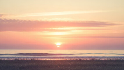 Serene sunset over calm waters and distant land