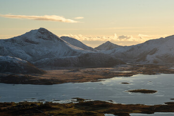 Golden Light Over a Snowy Mountain Fjord Landscape in Northern Norway
