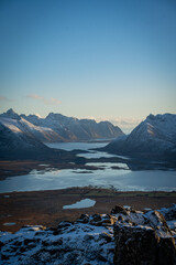 Panoramic View Over a Norwegian Fjord Valley Surrounded by Snowy Mountains