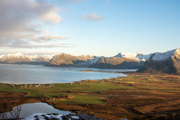 Wide Fjord Landscape With Green Fields and Snowy Mountains in Northern Norway