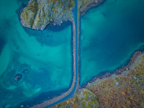 Top-Down Aerial View of a Coastal Road Between Turquoise Waters in Northern Norway