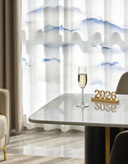 Minimalist luxury interior with marble table, single champagne glass and elegant 2026 gold sculpture, soft morning sunlight through white curtains, calm high-end lifestyle concept
