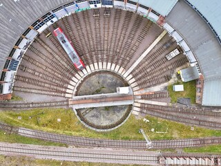 Aerial Top View of Railway Roundhouse with Turntable and Red Train