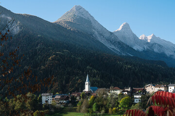 Valle di Cadore, Dolomites, Italy - Mountain Village scene in late summer early autumn fall with mountains and churches