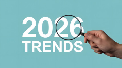 Hand holding magnifying glass over 2026 trends text in modern minimalist design with bold typography on blue background for business presentation