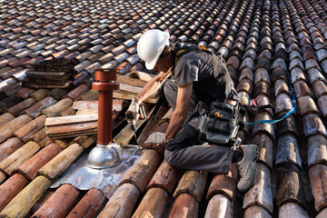 Roofer Installing Chimney on Residential Roof with Safety Harness, Installing Vertical Coaxial...