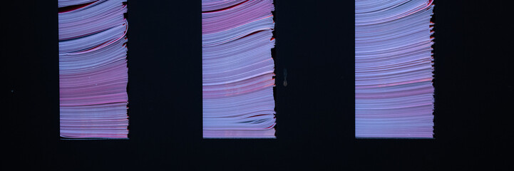 Abstract of Colourful paper magazine leaflets in rack holder for use as background texture