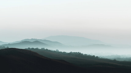 Obraz premium Wide minimalist hill landscape panorama with soft mist and muted colors, tranquil atmosphere, clean natural composition with copy space