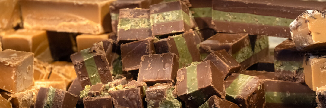 Closeup of pieces of mixed flavour chocolate fudge on a confectionery stall at a food market