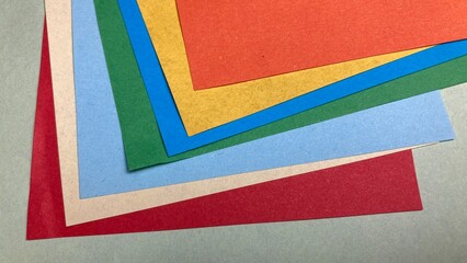 layered paper sheets in various colors and shapes. Abstract composition of colorful curved paper sheets. Designer paper in blue and pink. Empty space on monochrome paper