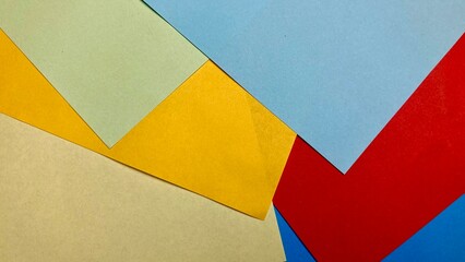 colorful paper sheets arranged in an artistic, Designer paper in blue and pink. Empty space on monochrome paper