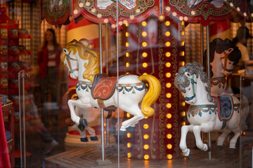 Fototapeta premium Vintage carousel horses inside Christmas attraction