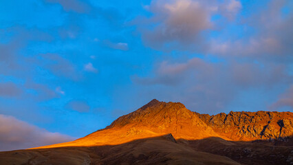 Naklejka premium Sunset with beautiful orange glow on the mountains of Kyrgyzstan.