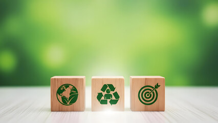 Three wooden blocks with eco friendly symbols on a green background representing sustainability and environmental goals
