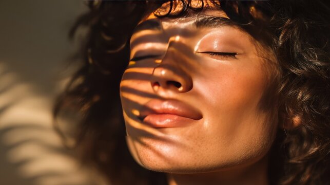 Individual enjoys bright sun rays casting striped shadows across the face