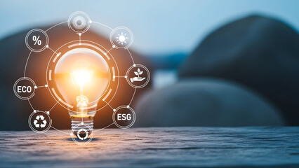 Eco friendly business concept with glowing light bulb and esg icons on a wooden surface outdoors