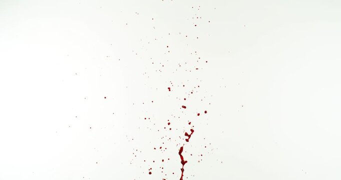 Blood Down Up Splashes in Super Slow Motion. Isolated on White Background. High-Speed Cinematic Shot of Blood Droplets Splashing in the Air.