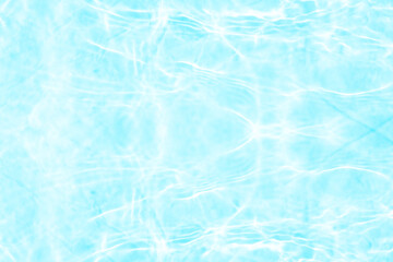 Obraz premium Blue water with ripples on the surface. Defocus blurred transparent blue colored clear calm water surface texture with splashes and bubbles. Water waves with shining pattern texture background.