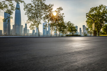 Motion-blurred asphalt roads and modern city buildings.
