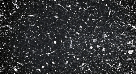 Black textured background with scattered white speckles and fragments image