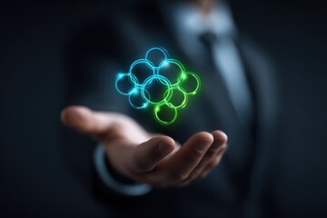 Hand holding glowing interconnected blue and green neon circles structure.