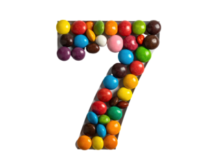 Number seven made of colorful, round, candy coated candies