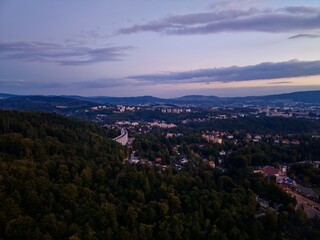 Obraz premium Evening Landscape With Glowing Streets, Dusk Aerial View Showcasing Roads And Tranquil Surroundings