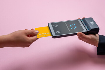 Payment card inserted into portable POS terminal showing processing screen, illustrating digital payment flow, loading state, and user interface workflow design