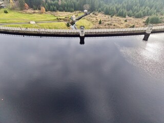visual representation of heavyduty concrete dam being examined with geometric fencing patterns