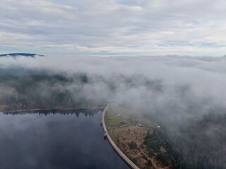 misty river landscape, shrouded dawn over water, veiled horizon with flowing mist and trees