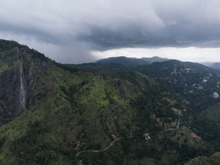 Naklejka premium Dramatic storm clouds gathering over the green mountains of Ella, Sri Lanka