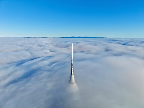 Advanced Monitoring Spire Emerges Through Fog Illuminated By Atmospheric And Radar Signals