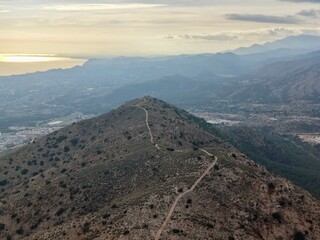 Obraz premium Winding Path Leads To Mountain Outlook, Secluded Trail Offers Breathtaking Scenes Of Ocean And Peaks