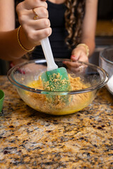 Step-by-step homemade chocolate chip cookie baking process, showing mixing wet and dry ingredients, folding in chocolate chips, and scooping raw cookie dough onto a baking sheet in a home kitchen. 