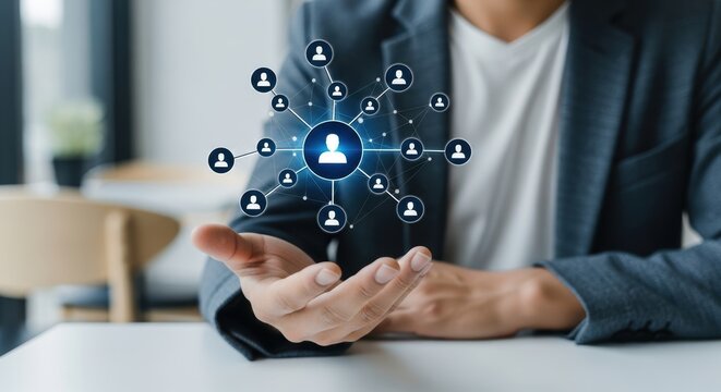 Person displaying glowing holographic network structure of user connections in a bright modern office - Powered by Adobe