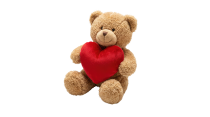 A tan teddy bear holding a red heart shaped object is centered in the frame and facing the viewer on a white surface no background