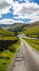 A winding road through a lush valley with a river. Rolling hills are under a bright blue sky with fluffy clouds