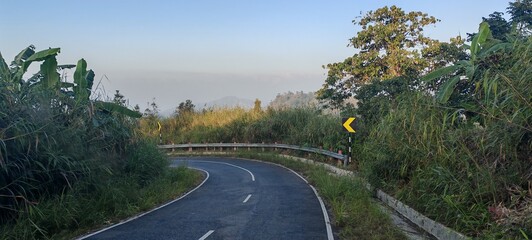 Curvy asphalt road in tropical mountains