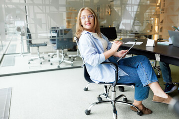 Woman sitting at desk in modern office space