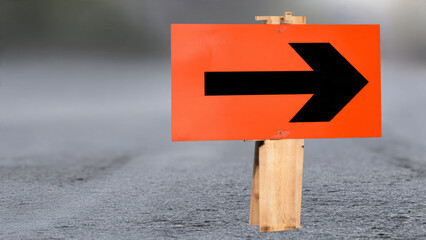 Orange Road Sign with Arrow