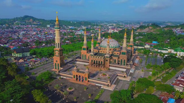 a 4k footage aerial view of islamic center or baitul muttaqien mosque in samarinda with blue sky