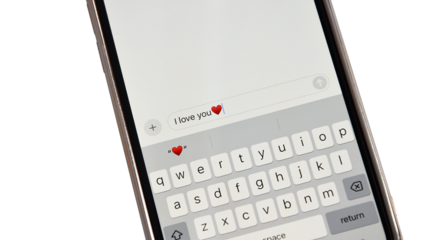 Smartphone screen displaying I love you text message with heart emoji on  keyboard