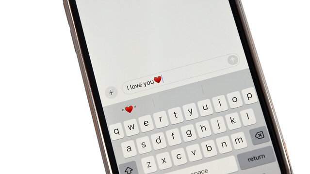 Smartphone screen displaying I love you text message with heart emoji on  keyboard - Powered by Adobe