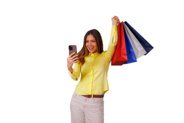 Happy woman holding colorful shopping bags and smartphone, celebrating successful shopping spree with a joyful selfie pose